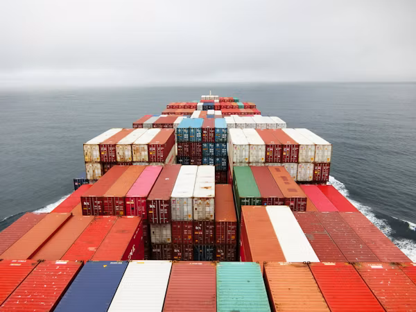 Container vessel sailing through a maritime port